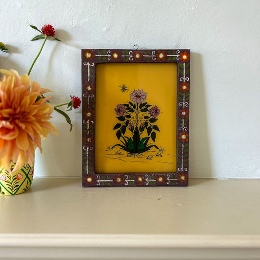 Decorative framed artwork with floral design on a white surface. onstance-and-denny-indian-reverse-glass-painting-boxed-packaging-hand-painted-artisan-art-flowers