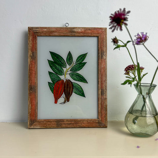 Framed stained glass artwork of leaves and flowers on a table with a vase of flowers. INDIAN-GLASS-REVERSE-PAINTING-CACAO