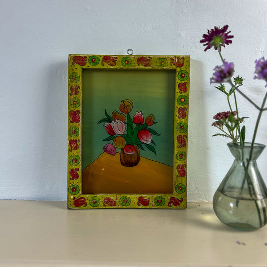 Decorative frame with floral painting on a white wall. indian-glass-painting-painting-all-the-colours-tulips