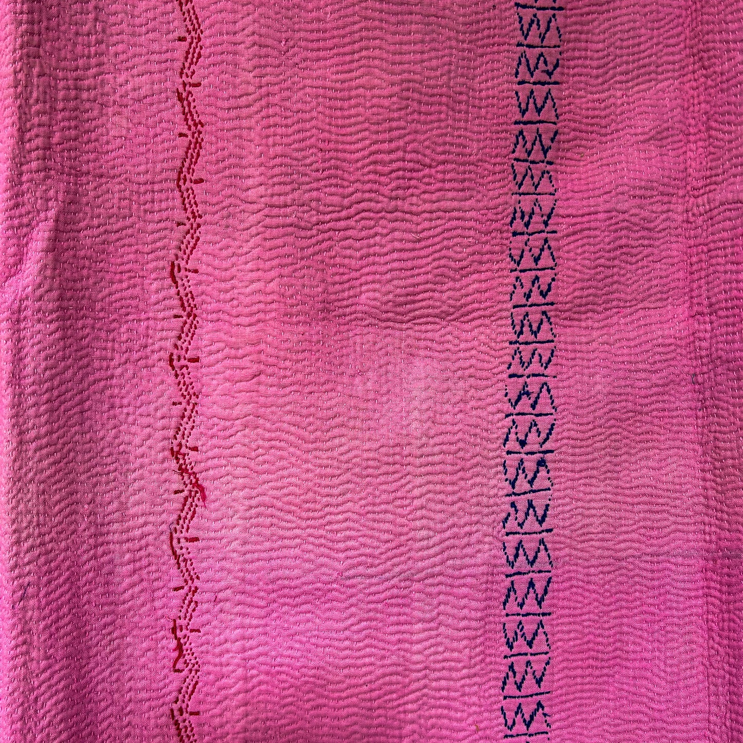 Close-up of pink fabric with black geometric pattern