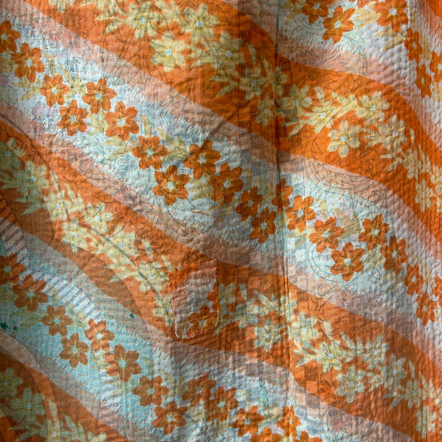 Floral patterned fabric with orange and beige colors