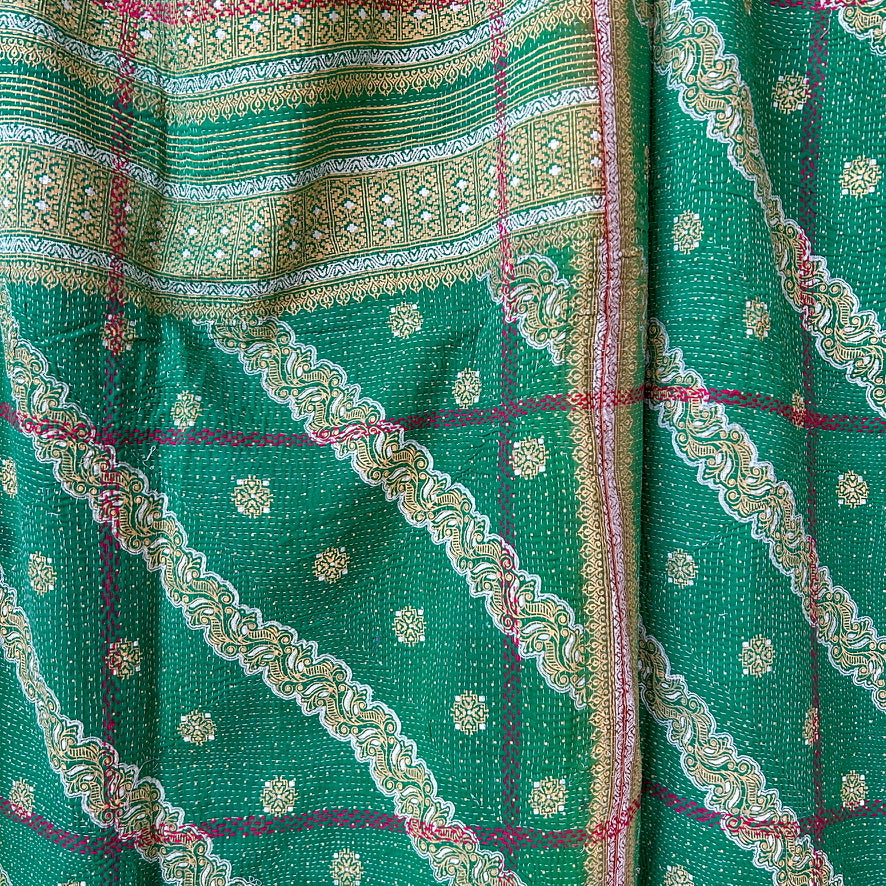 Green fabric with intricate gold and pink patterns