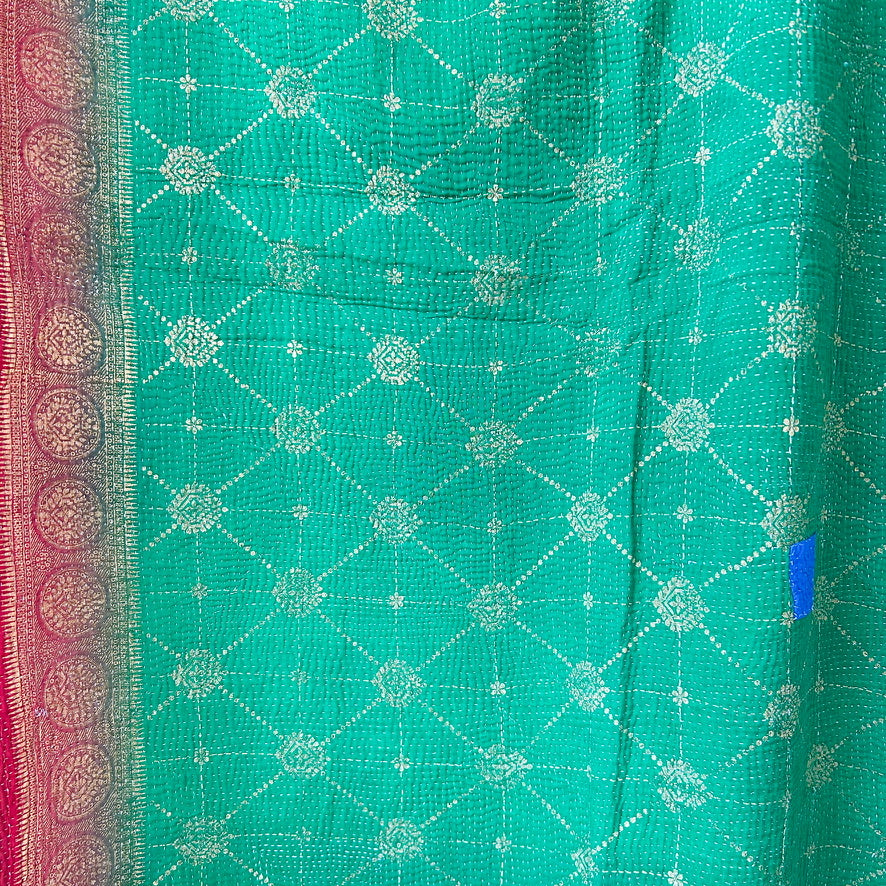 Green fabric with white geometric pattern and pink border. kantha-vintage-2026-hand-made-blanket-throw-textiles-wall-hanging