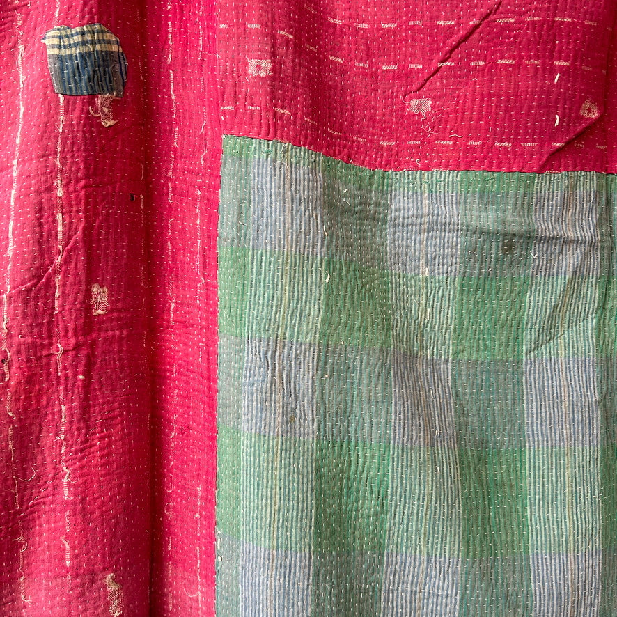 Close-up of a red and green checkered fabric with visible texture.