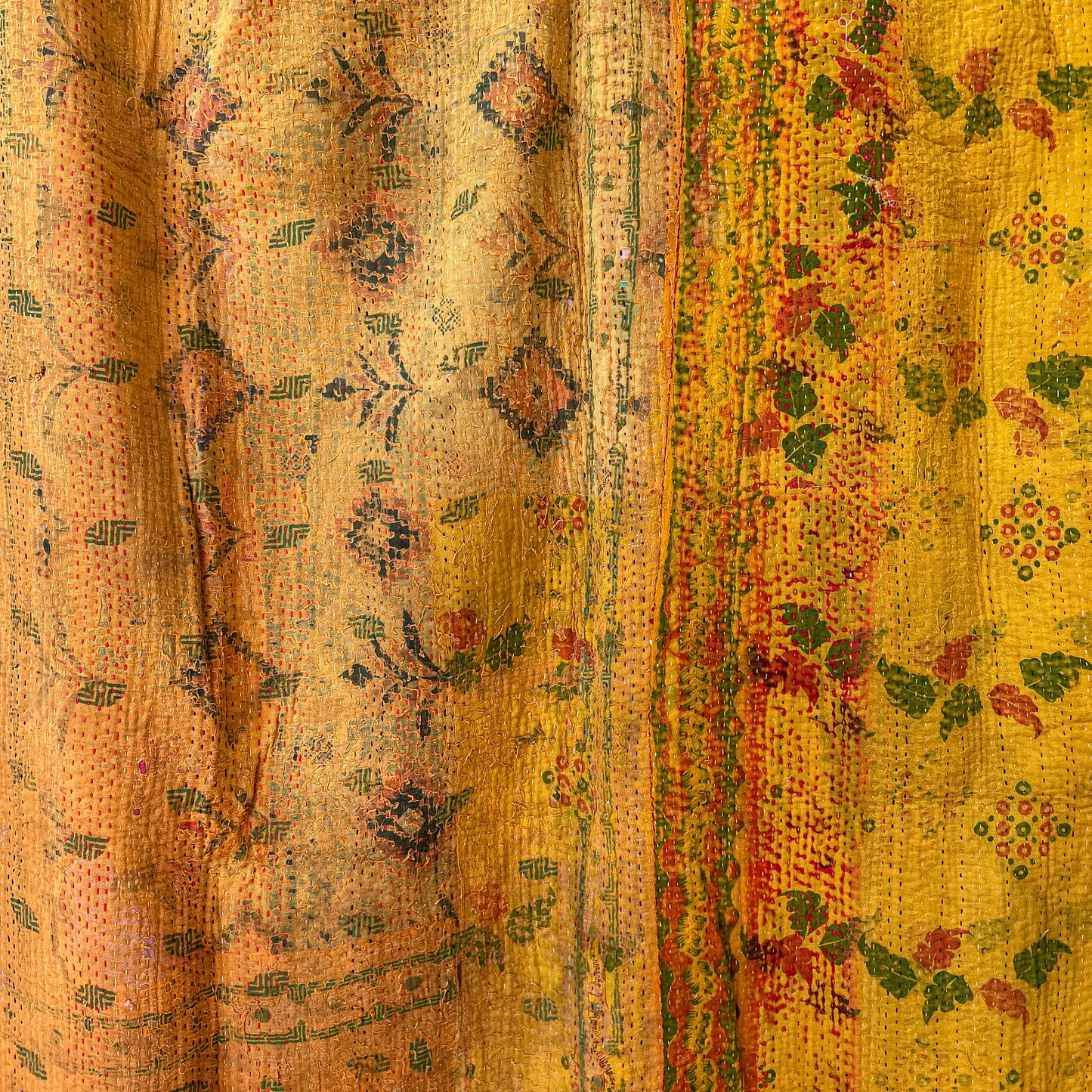 Close-up of patterned fabric with a mix of yellow, orange, and green colours.vintage-kantha-2014-textiles-blanket-golden-Detail