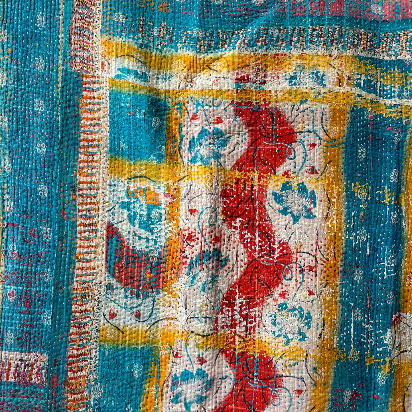 Colorful textured fabric with a mix of blue, red, yellow, and white patterns. vintage-kantha-2014-textiles-blanket-multi-coloured