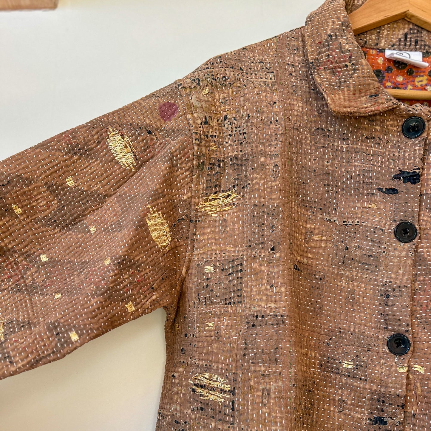 Brown textured jacket with gold accents on a white background. vintage-kantha-button-23-shirt-style-sleeve