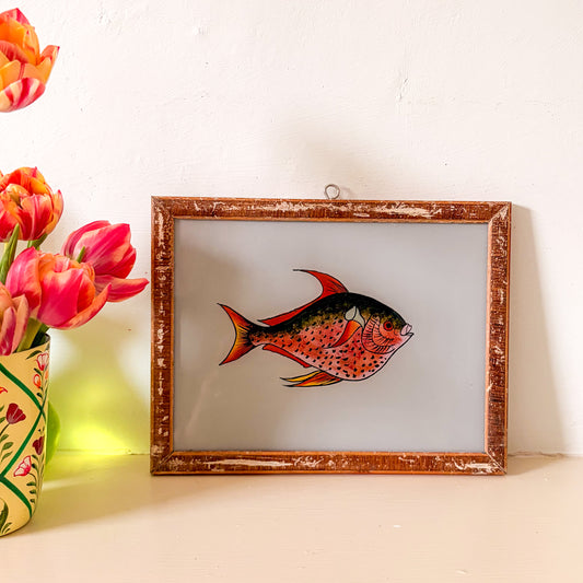 Framed artwork of a fish with tulips on a white surface