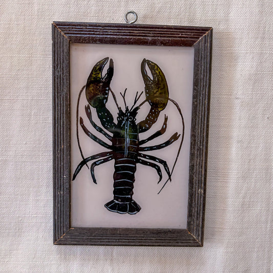 Framed artwork of a lobster on a textured beige background