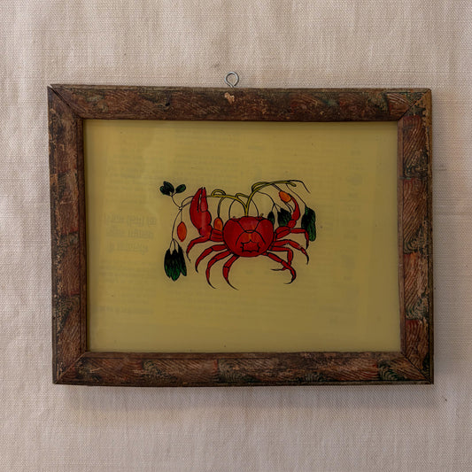 Framed artwork of a red crab on a beige background