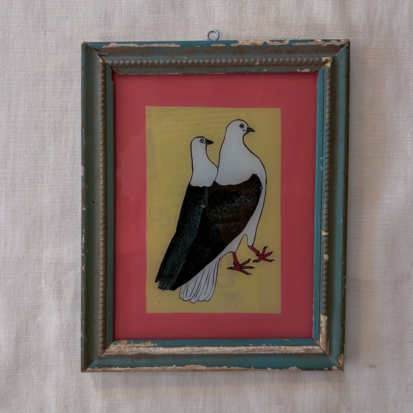 Framed artwork of two birds on a red and yellow background