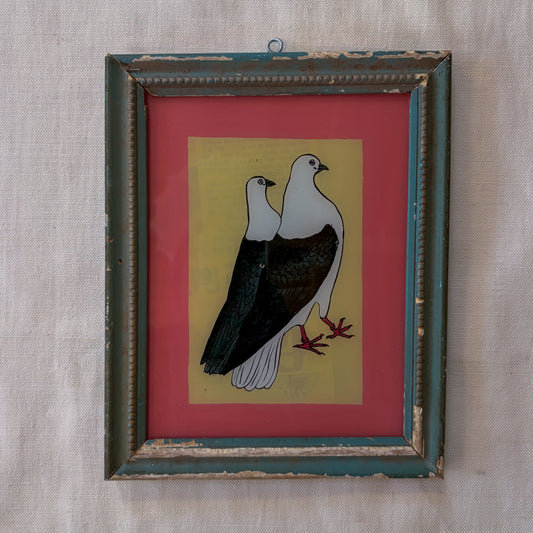 Framed artwork of two birds on a red and yellow background