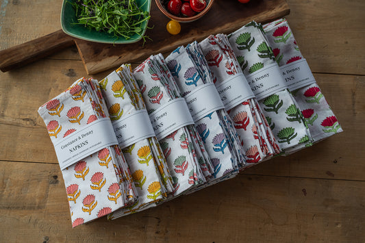 Set of patterned napkins on a wooden surface with a rustic background