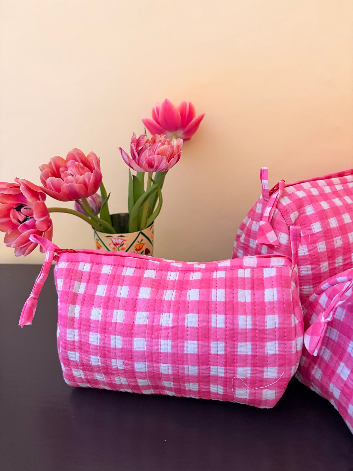 Pink checkered bag with flowers on a beige and brown background