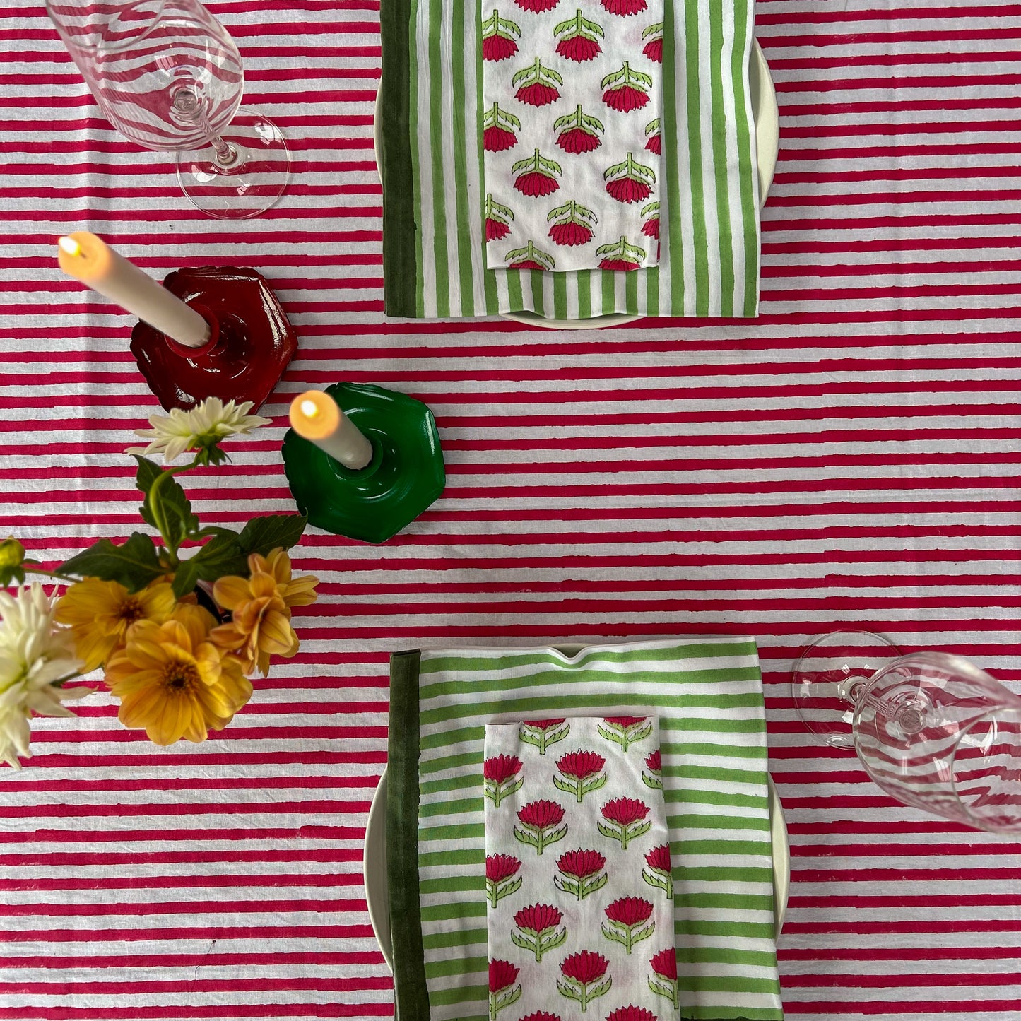 Hand block printed cotton tablecloth in joyful red stripes with a floral border — ethically made, colourful, and perfect for every gathering.