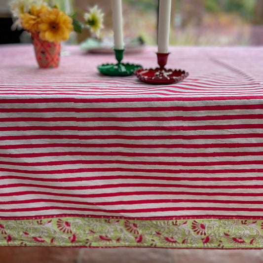 Hand block printed cotton tablecloth in joyful red stripes with a floral border — ethically made, colourful, and perfect for every gathering.