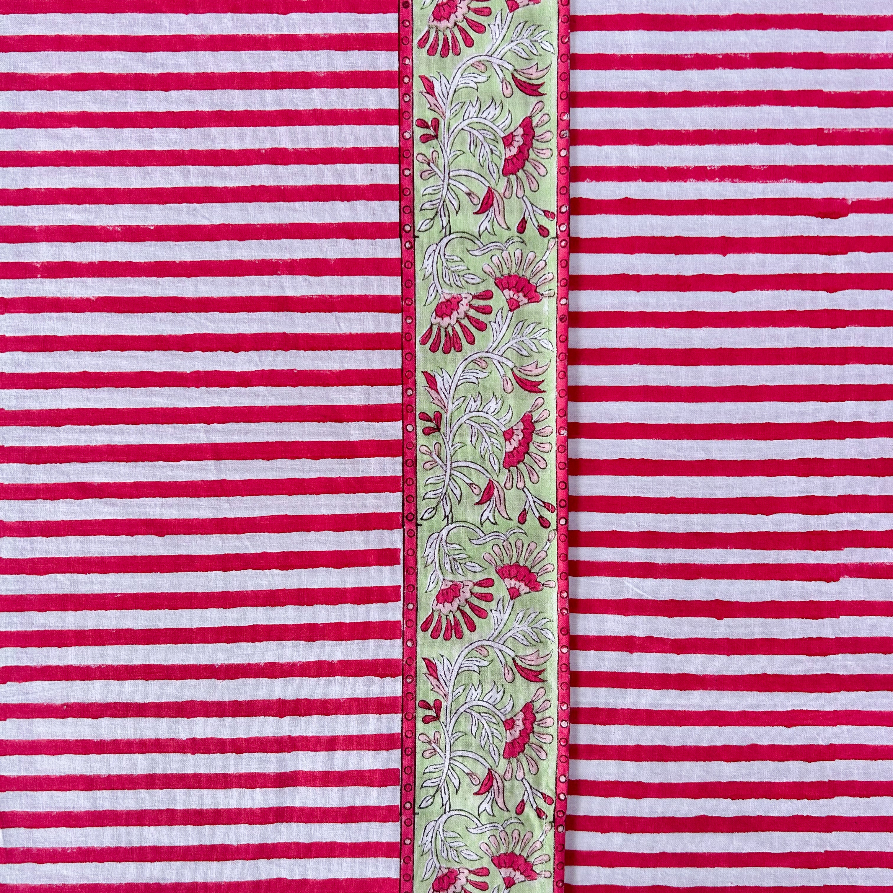 Hand block printed cotton tablecloth in joyful red stripes with a floral border — ethically made, colourful, and perfect for every gathering.