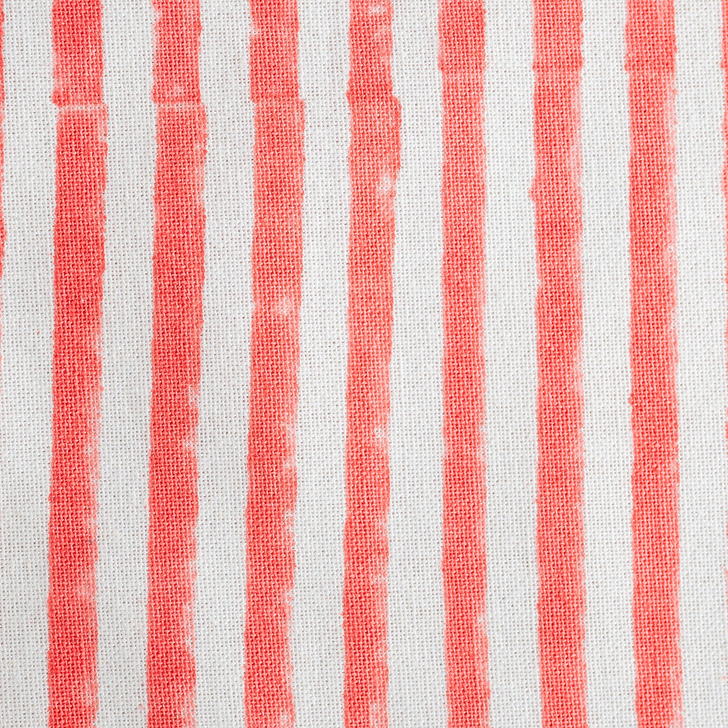 Close-up of fabric with red and white vertical stripes.