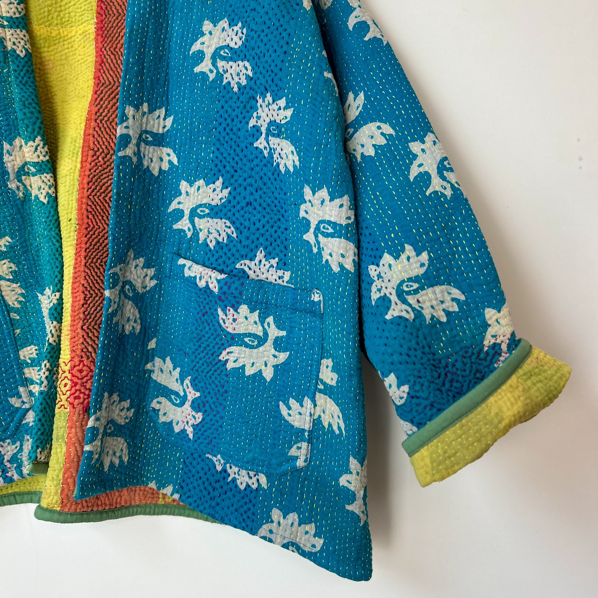 Colorful kantha with white floral patterns on a white background. Vintage-kantha-jacket-handmade-unique-38-turquoise-pattern-sleeve