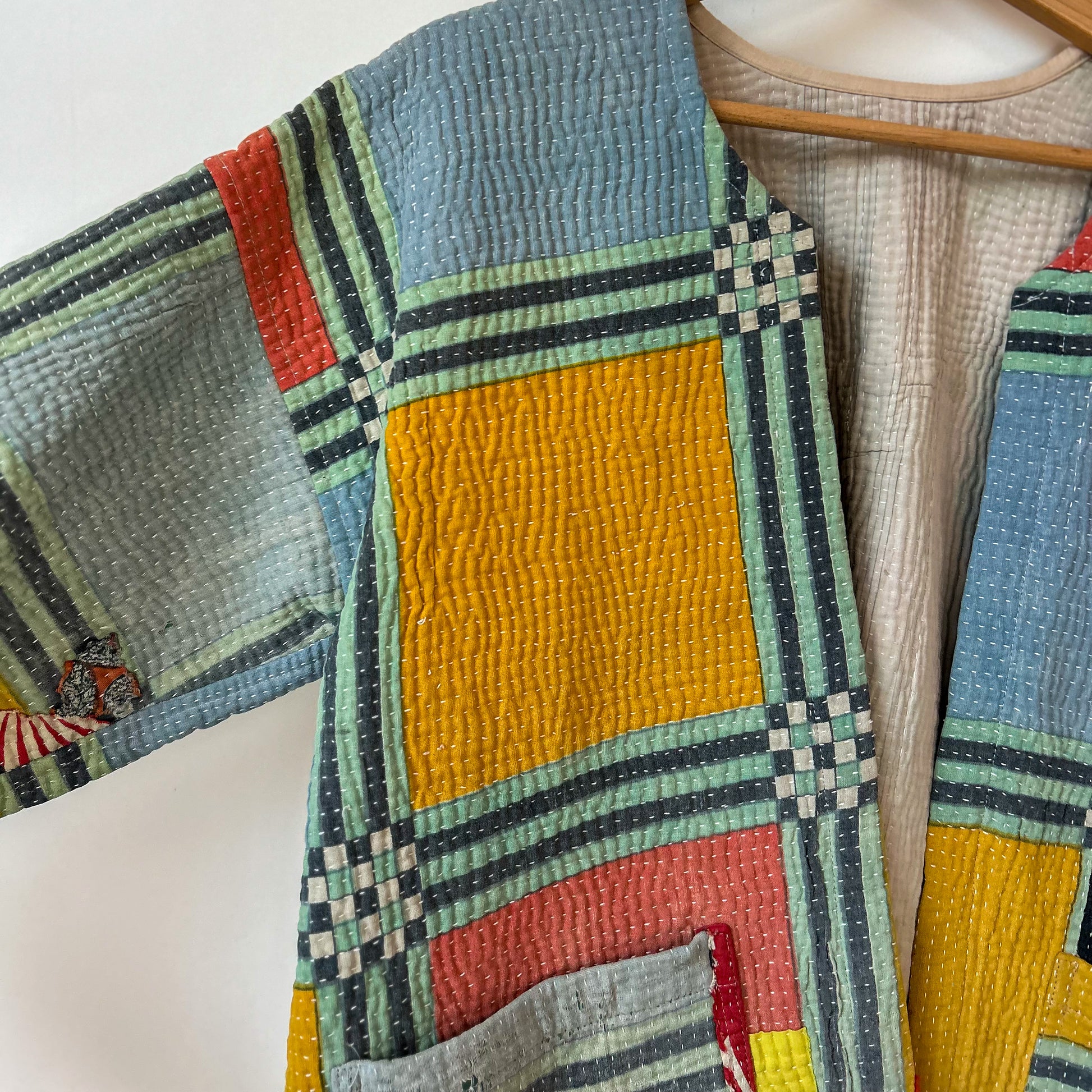 Colourful kantha with geometric pattern on a white background. Vintage-kantha-jacket-handmade-unique-39-geometric-colourful