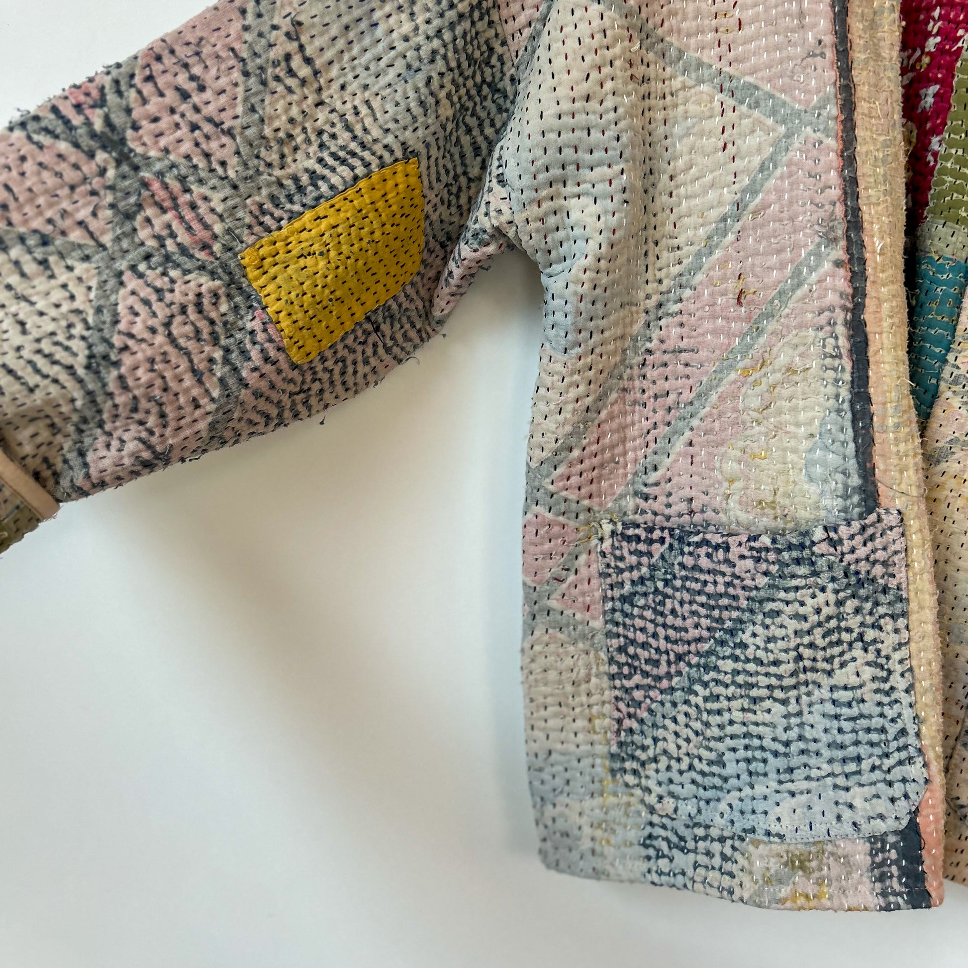 Textured fabric with geometric pattern on a white background. Vintage-kantha-jacket-handmade-unique-40-textured