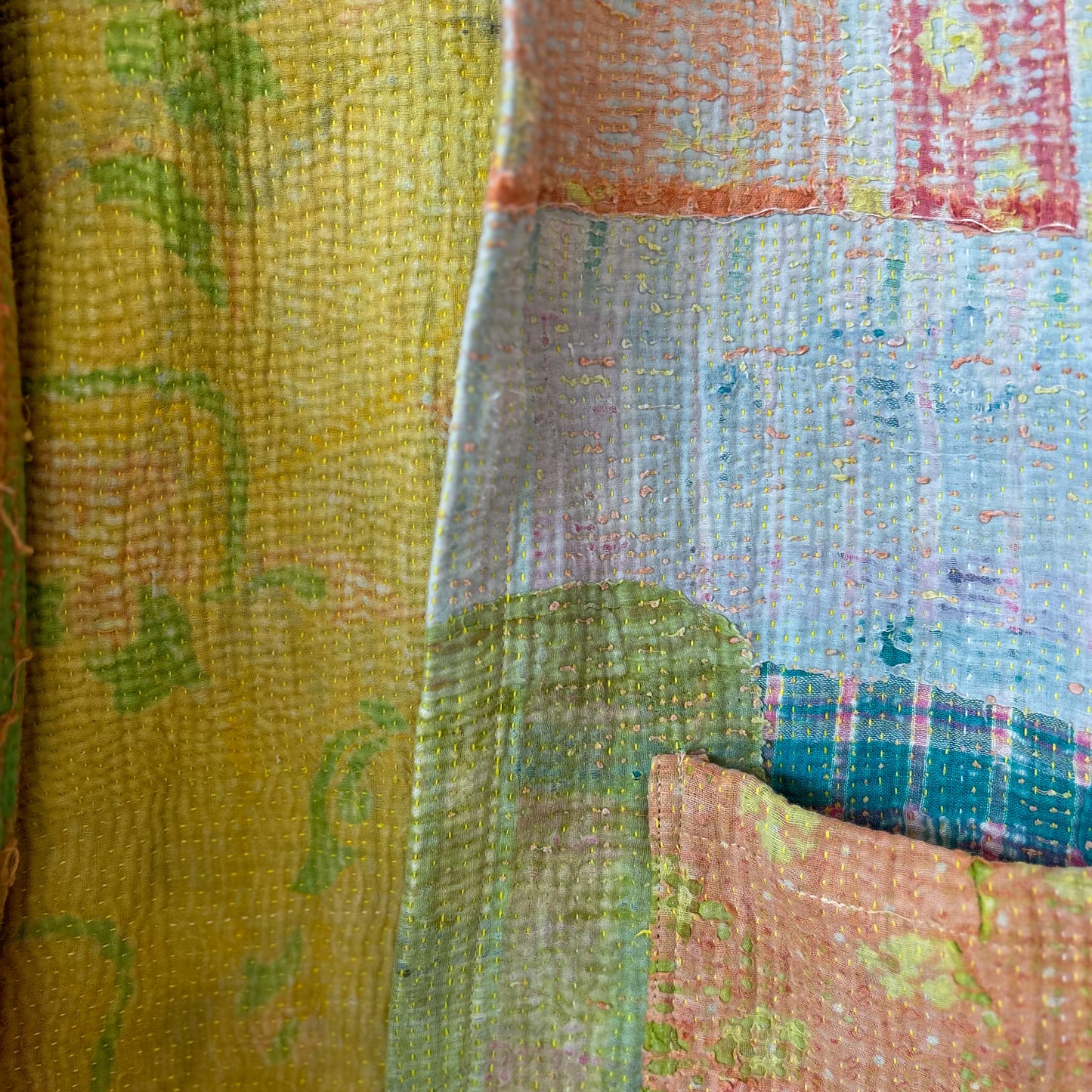 Close-up of a multicolored fabric with a patchwork pattern. Vintage-kantha-jacket-handmade-unique-41-textured-detail