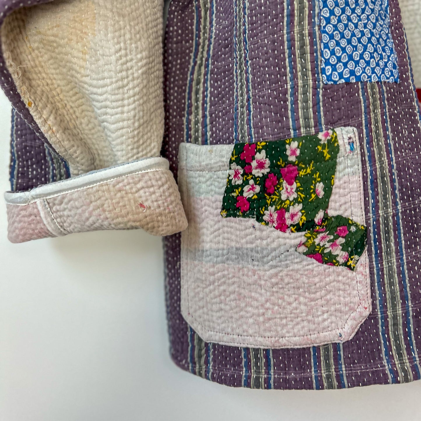 Patchwork fabric with floral pocket on a white background. Vintage-kantha-jacket-handmade-unique-mauve-34-sleeve-detail