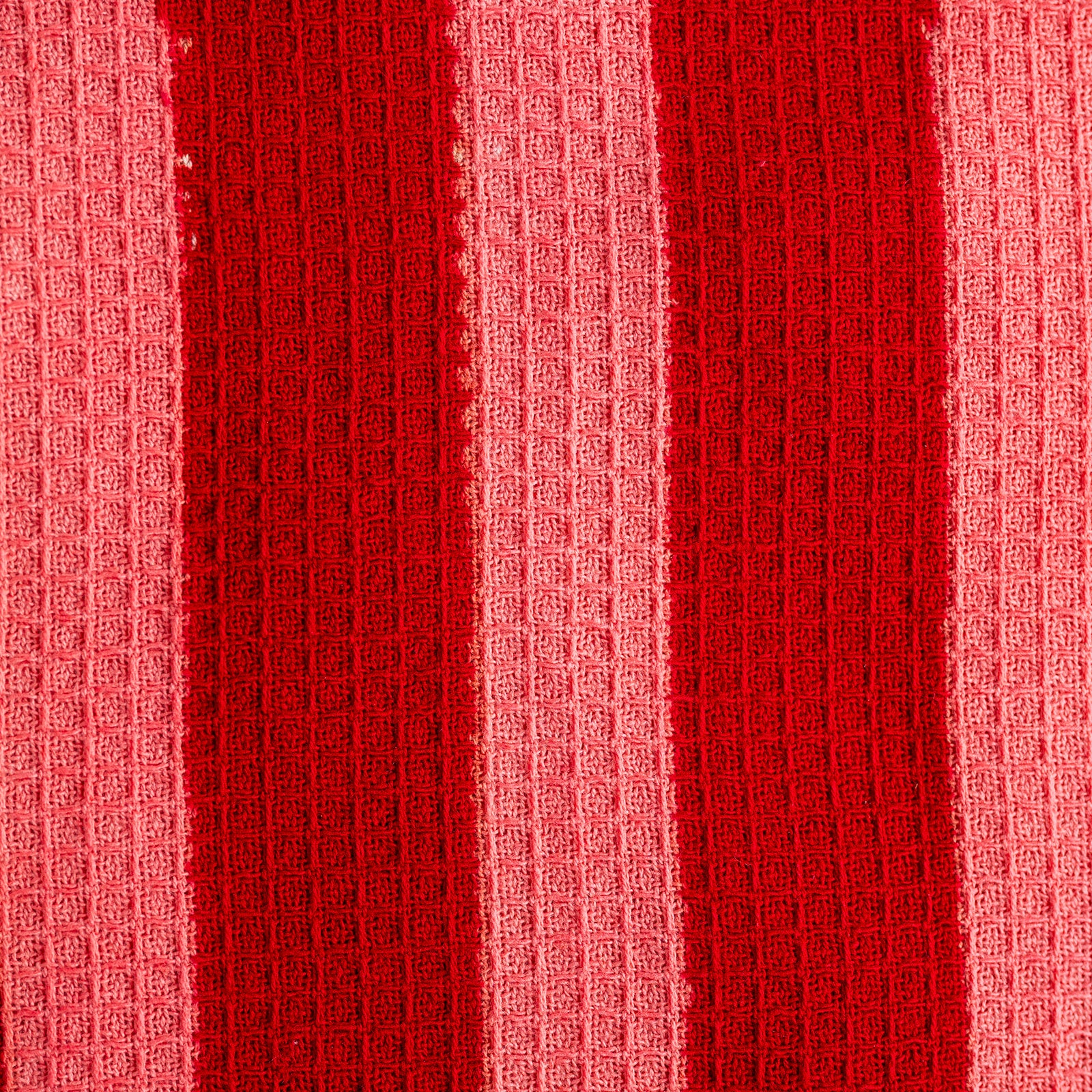 Close-up of red textured fabric with a waffle pattern