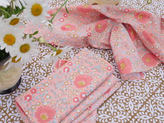 peach napkins in the summer on a tablecloth