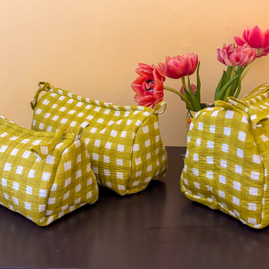 Alchemilla checkered bags with pink tulips on a brown surface