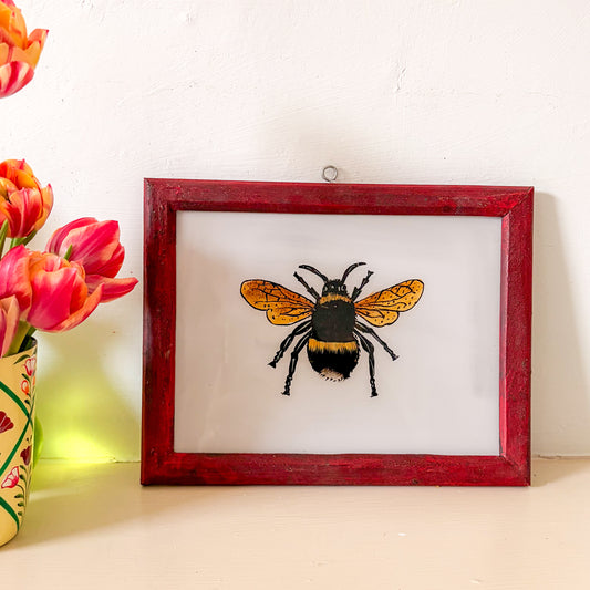 Framed picture of a bee with pink tulips on a white background