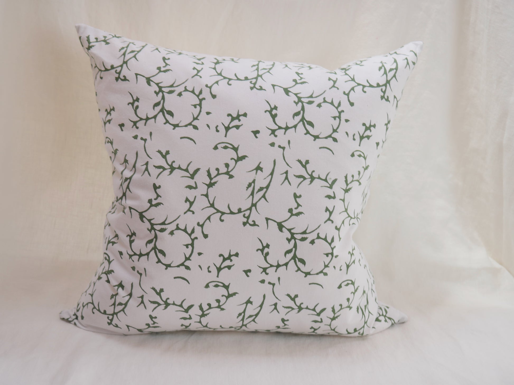 block printed cushion with feather pad
white background with green