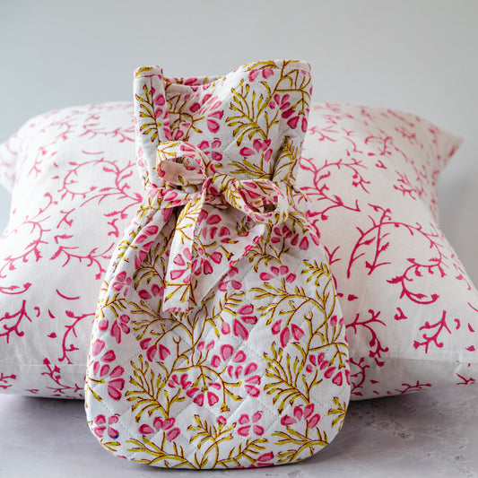 Fabric drawstring bag with floral pattern on a matching fabric background