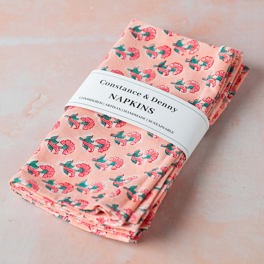 Pack of floral napkins with 'Constance & Denny' label on a light background