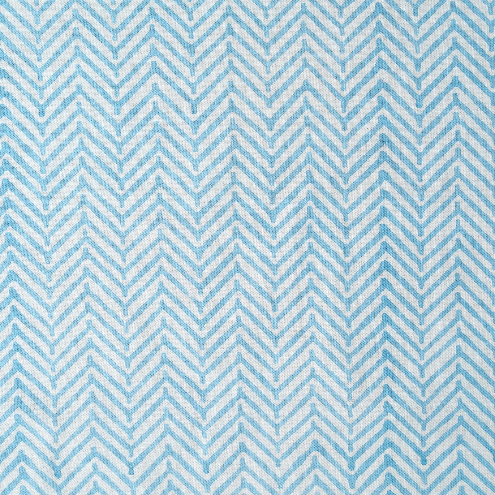 Pattern of blue and white chevron stripes on a blue background