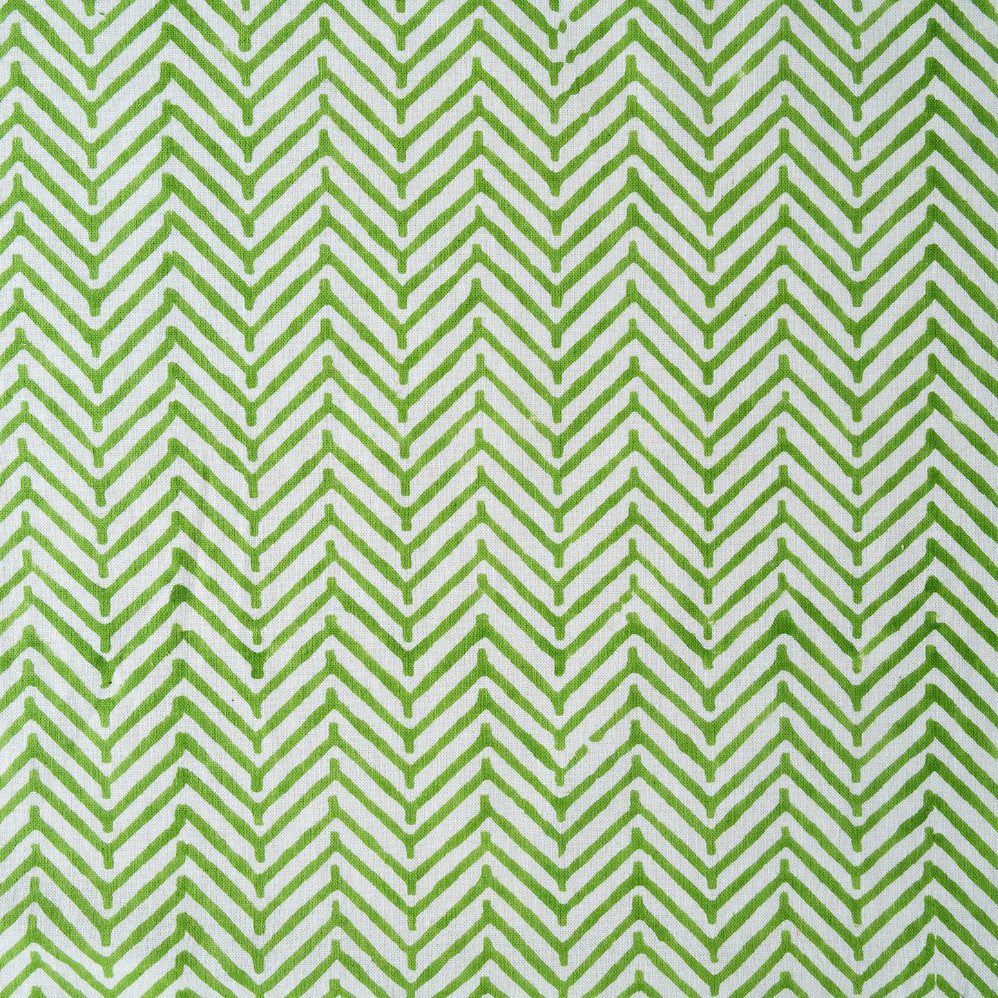 Green and white chevron pattern on a fabric background