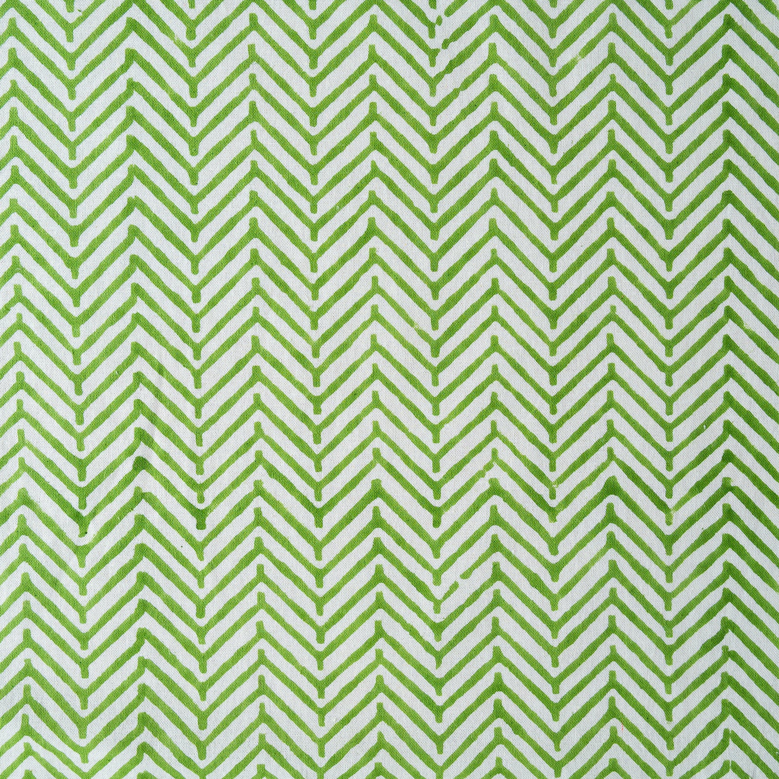 Green and white chevron pattern on a fabric background
