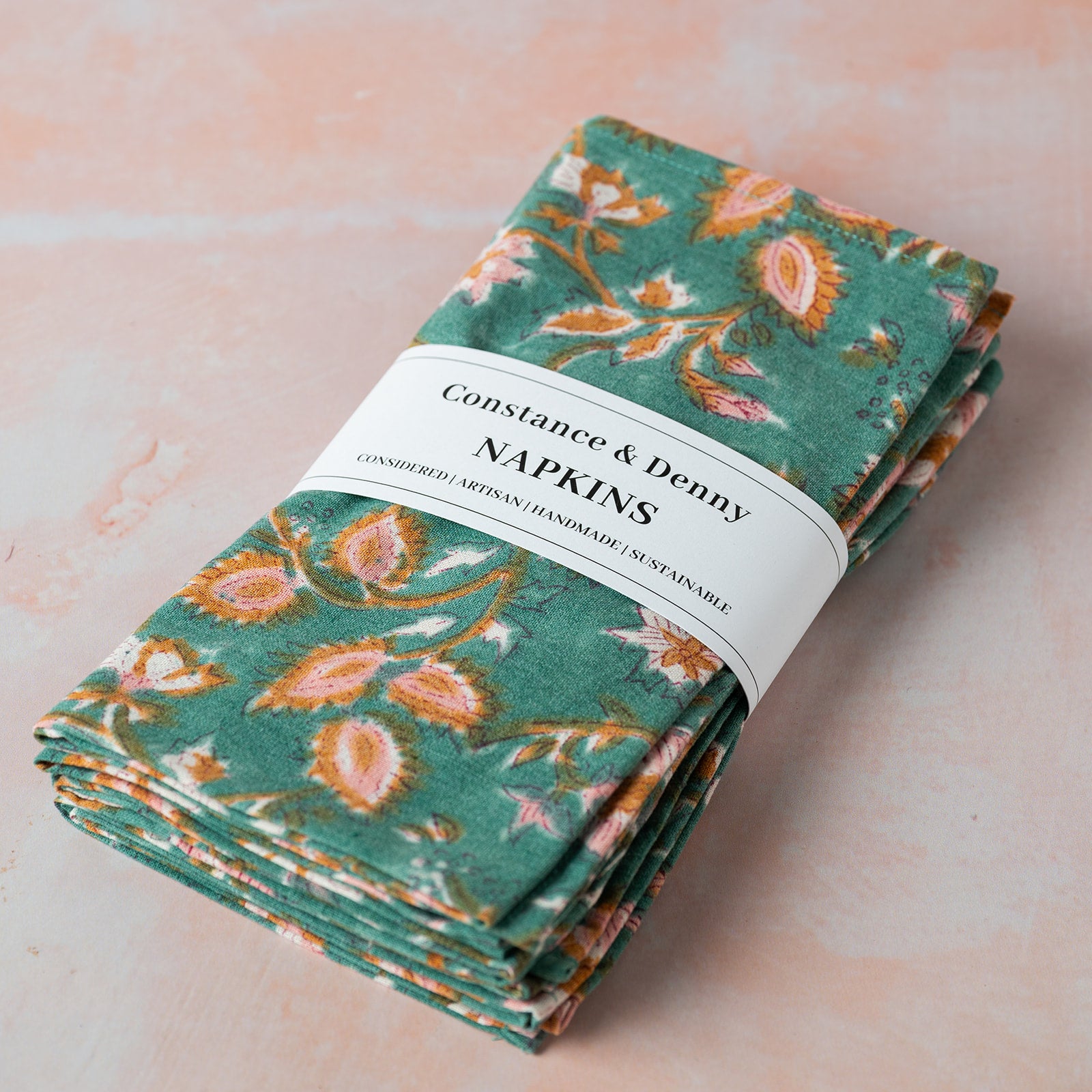 Pack of floral napkins with 'Constance & Penny' label on a light background