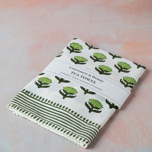 Tea towel with green artichoke pattern on a light background