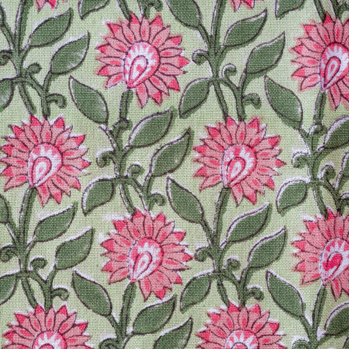 Pattern of pink flowers with green leaves on a light green background
