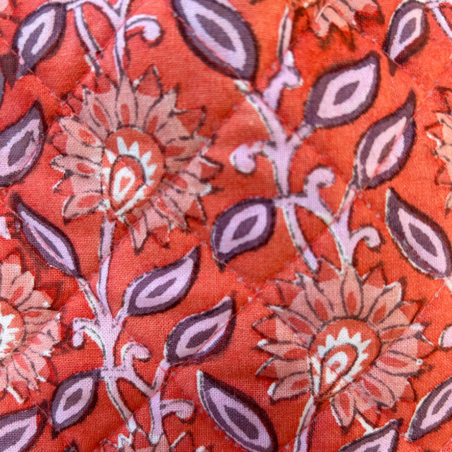 Close-up of floral patterned fabric with red background