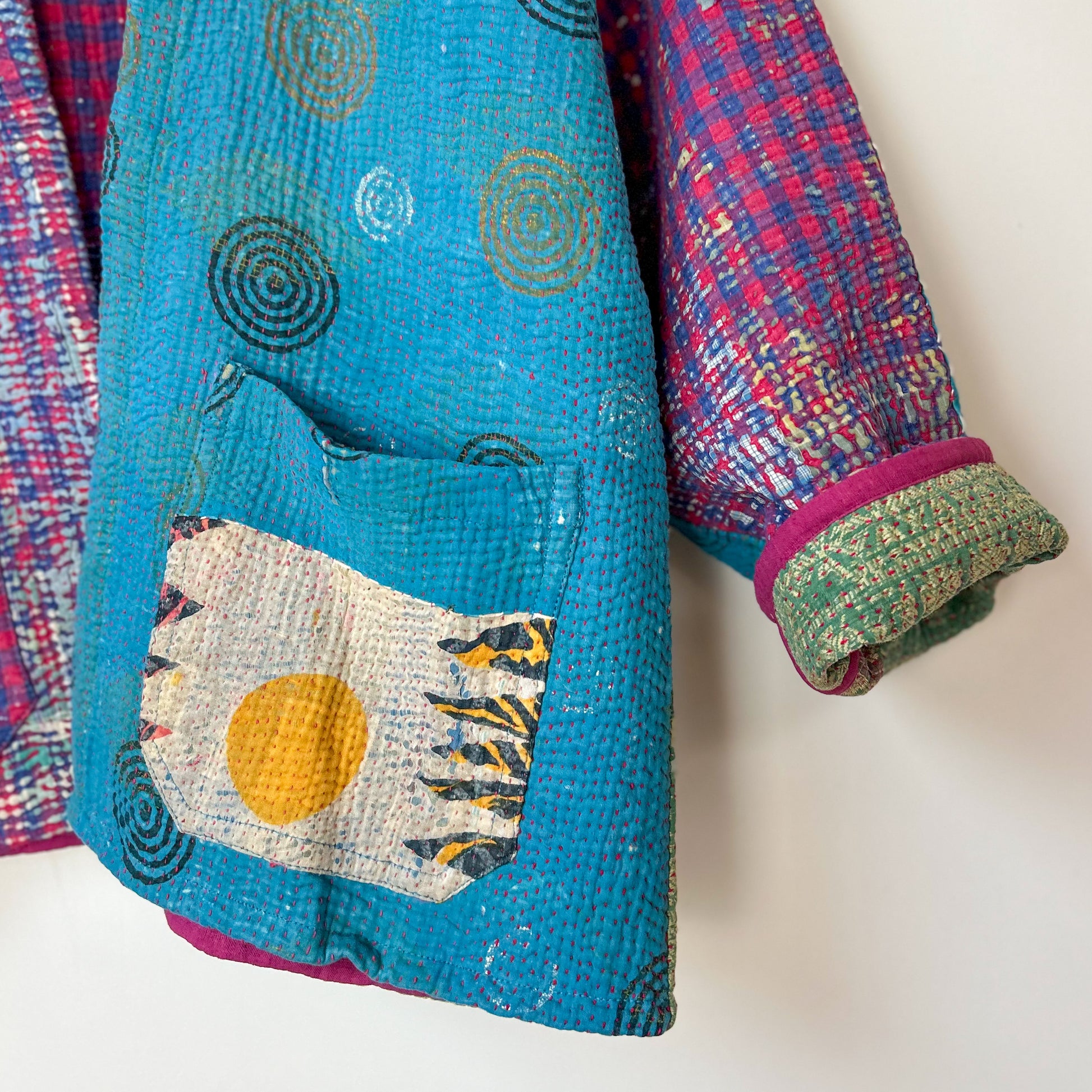 Colorful quilt with geometric patterns on a white background. kantha-kacket-handmade-vintage-modern-colourful-blue-violet-33-detail