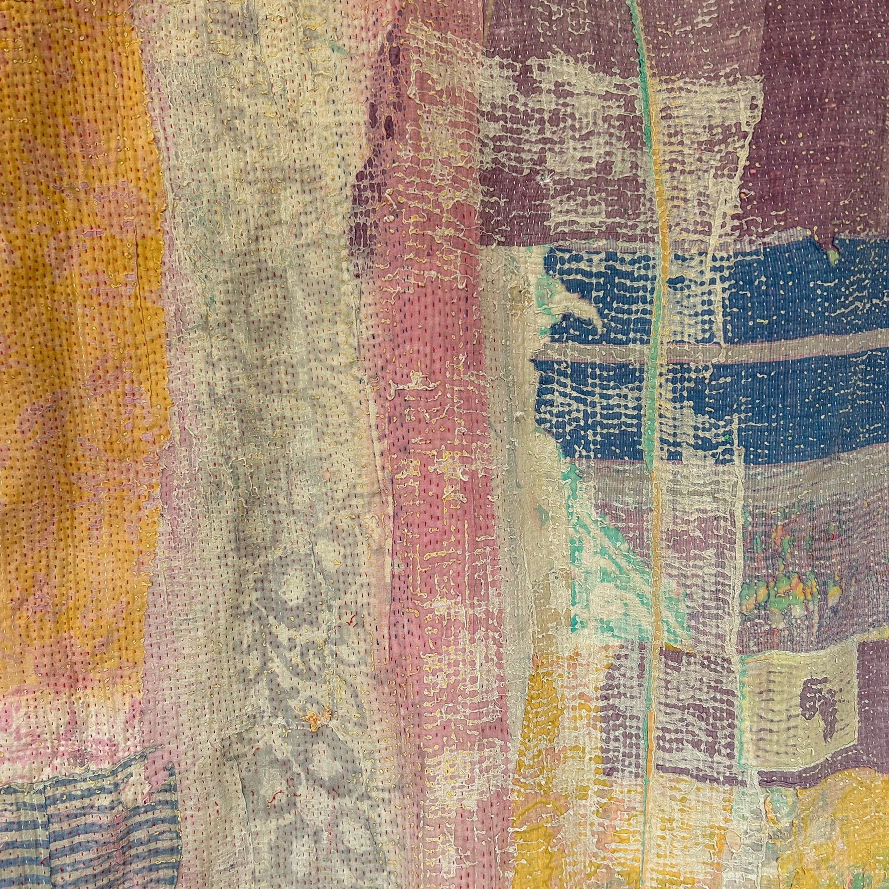 Close-up of a textured fabric with multicolor pattern. kantha-vintage-2032 - hand-made-blanket-throw-textiles-wall-hanging- detail