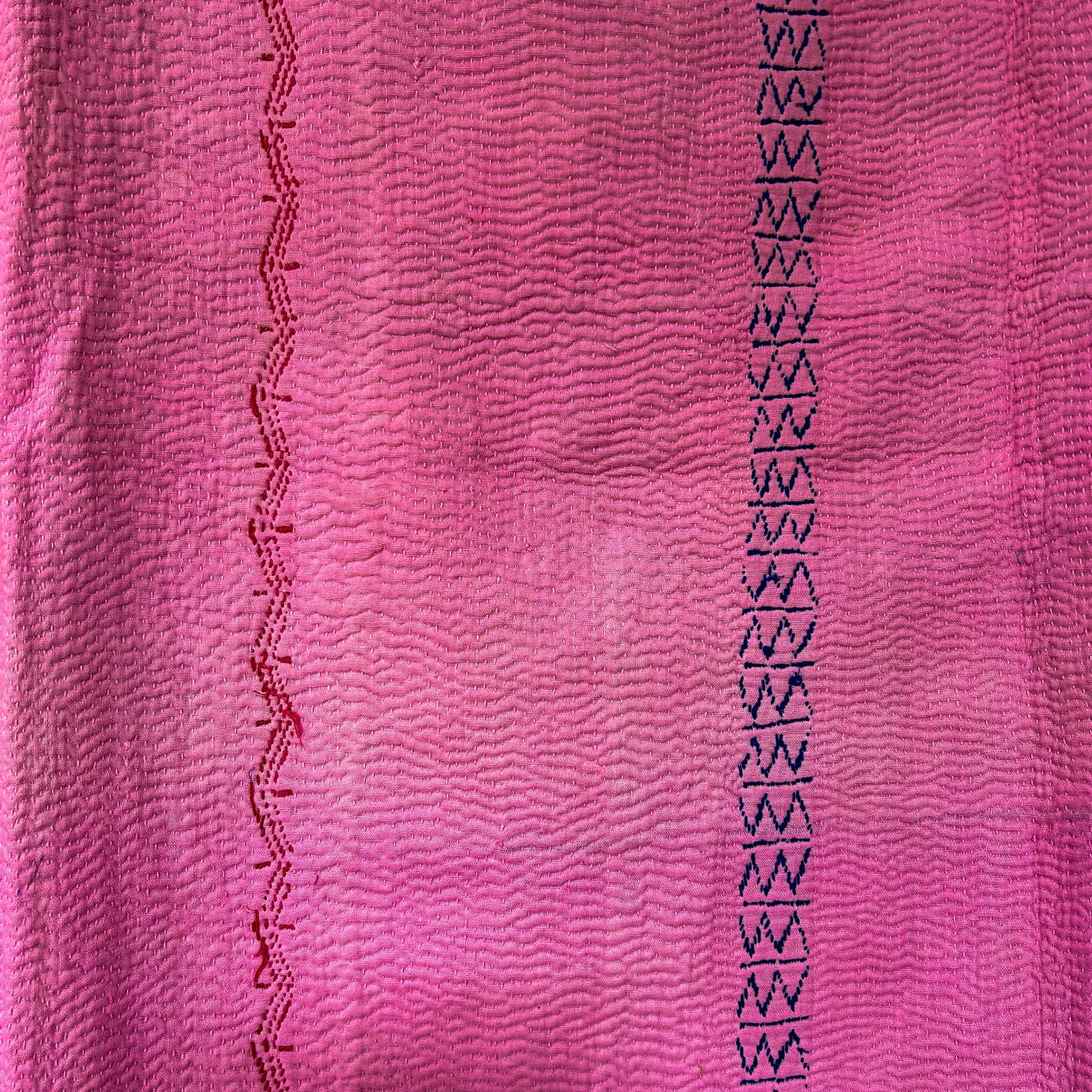 Close-up of pink fabric with black geometric pattern