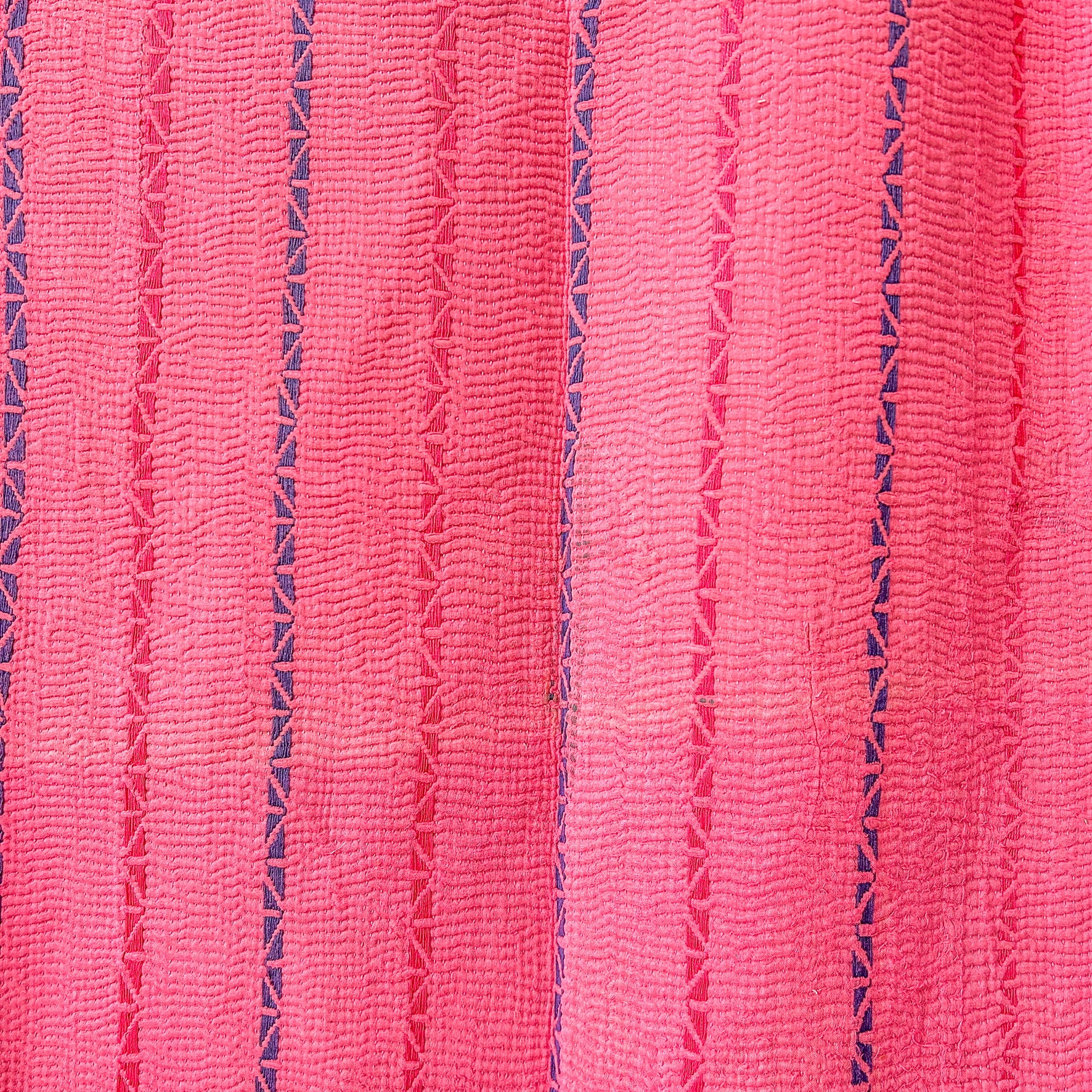 Close-up of pink fabric with a textured pattern.  kantha-vintage-2036- hand-made-blanket-throw-textiles-wall-hanging