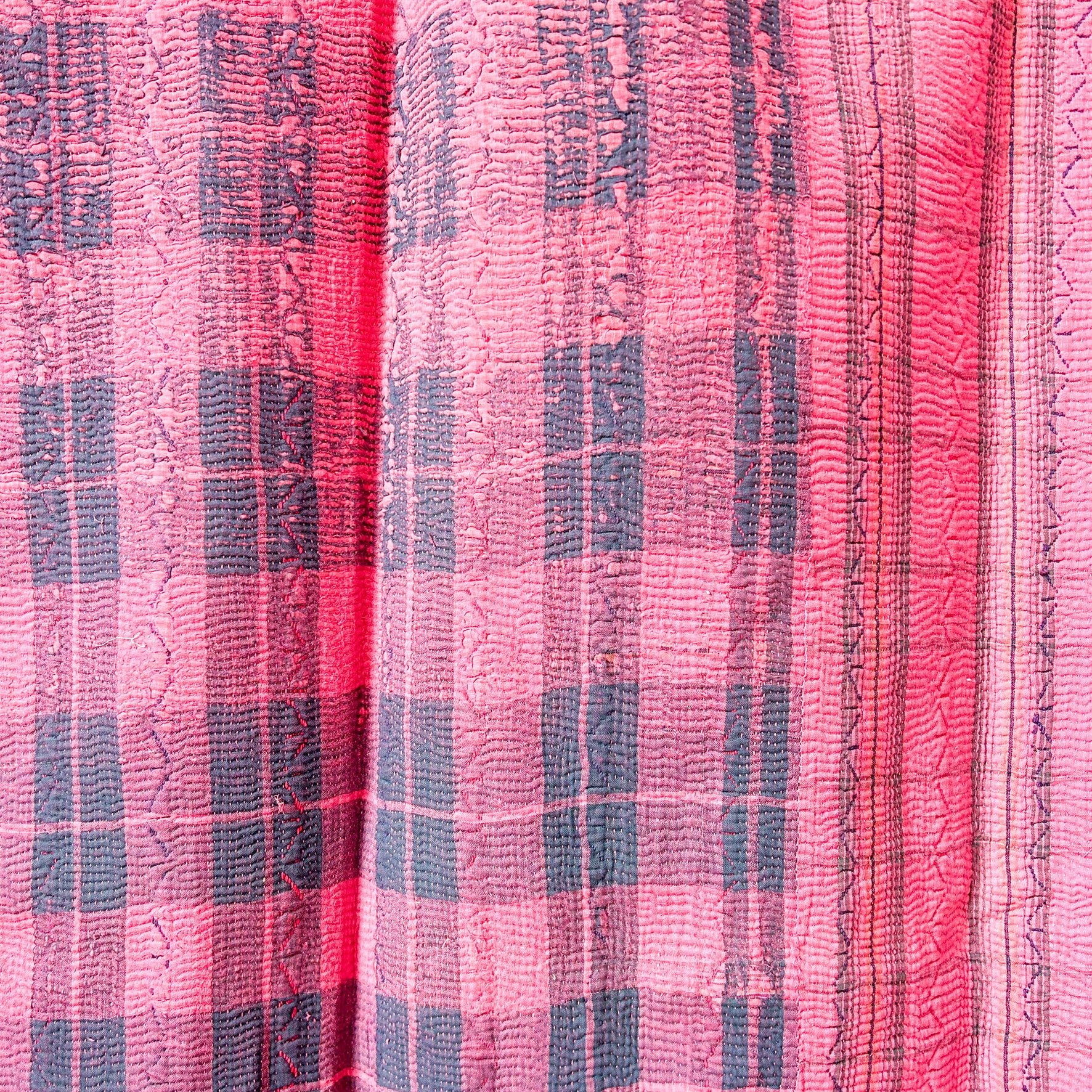 Close-up of pink fabric with a checkered pattern.  kantha-vintage-2036- hand-made-blanket-throw-textiles-wall-hanging