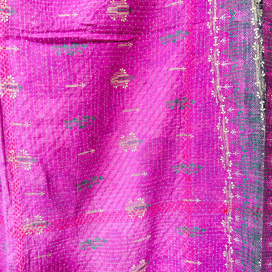 Close-up of a pink fabric with intricate patterns and designs.