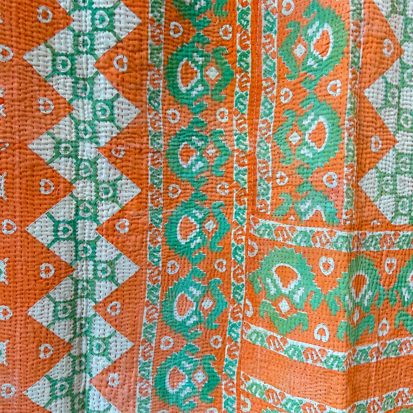 Close-up of orange, green, and white patterned fabric