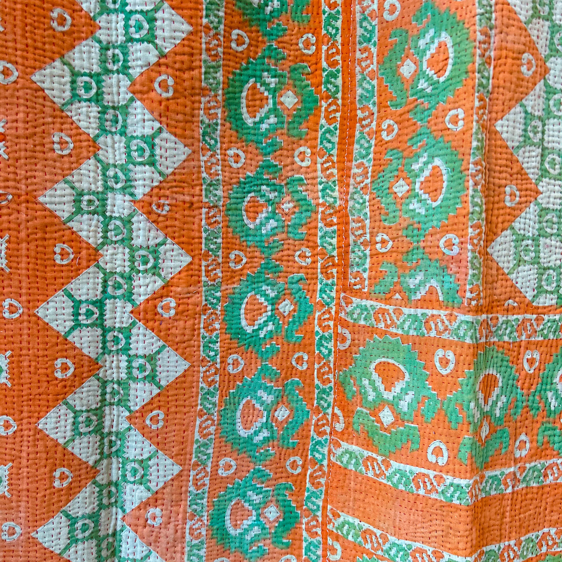 Close-up of orange, green, and white patterned fabric