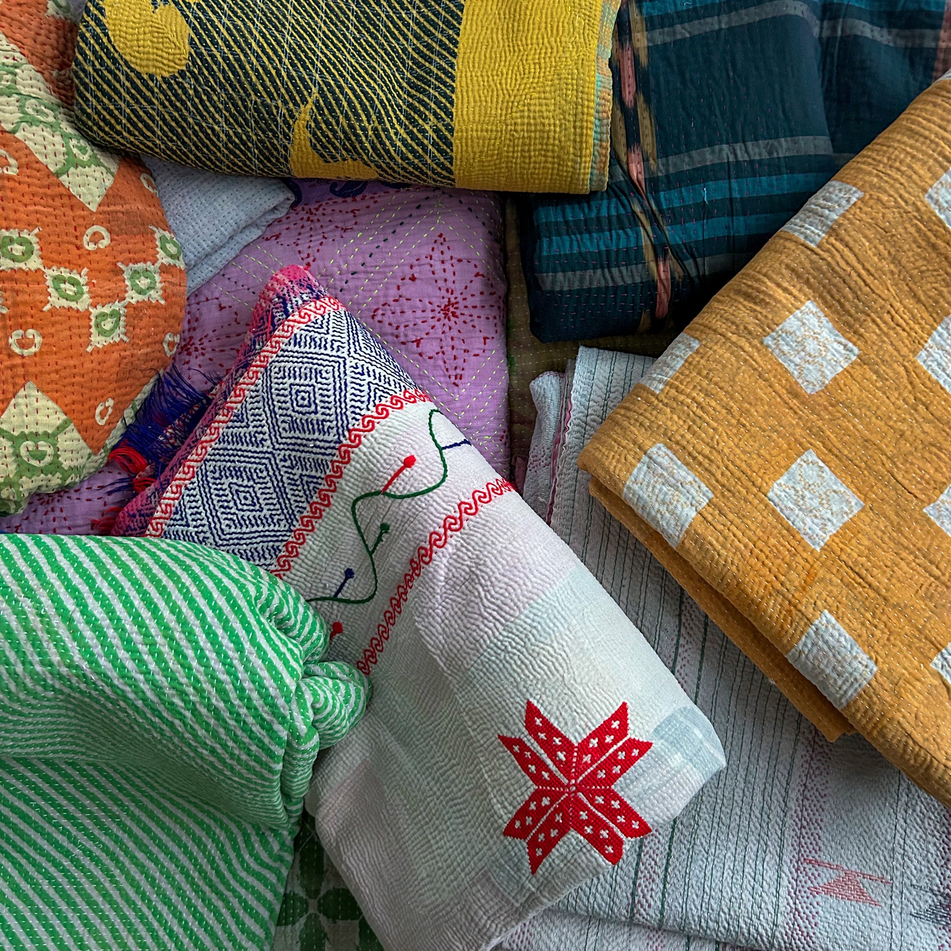 Collection of colorful fabrics with various patterns and colors.